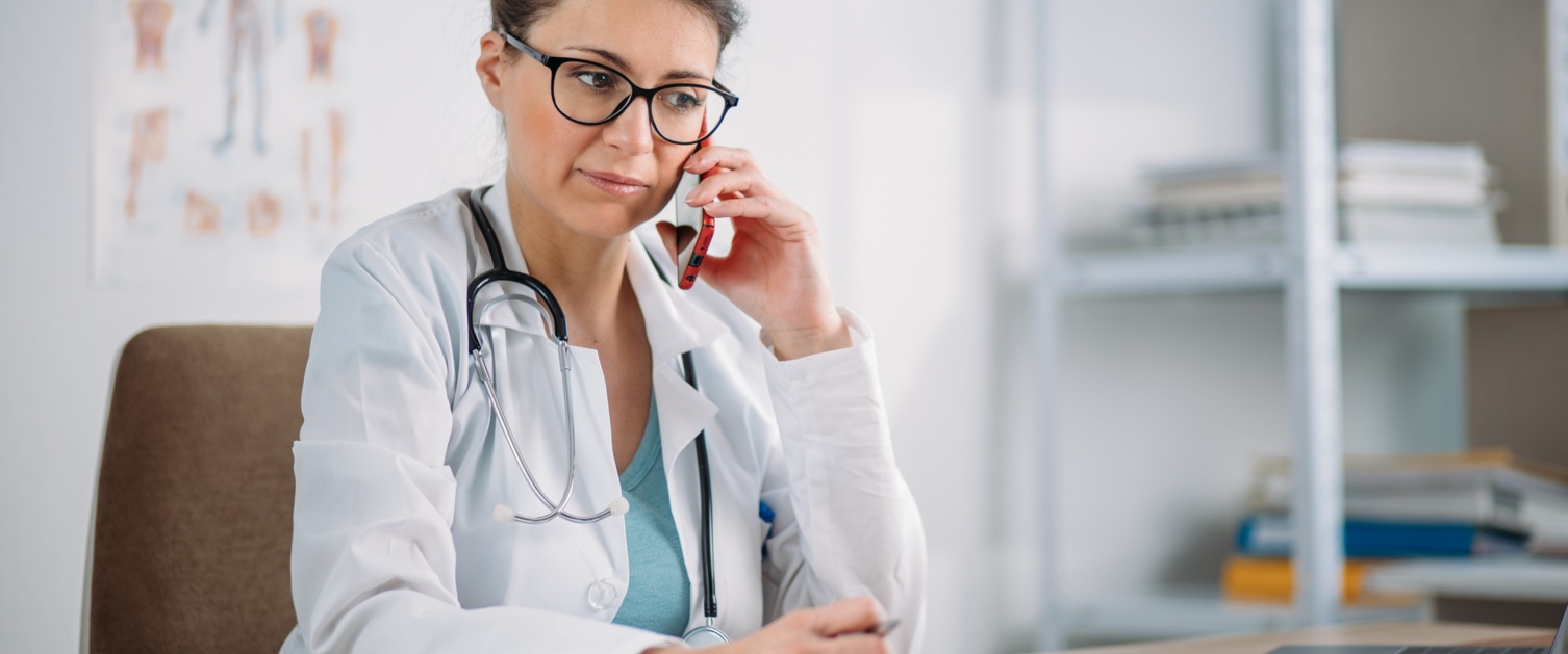 Image of a doctor on the phone in a medical setting