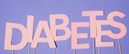 Diabetes logo in pink with a purple background
