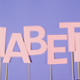 Diabetes logo in pink with a purple background