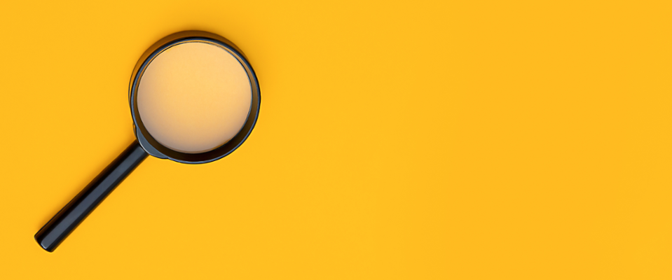 Black Magnifying glass on a Yellow background