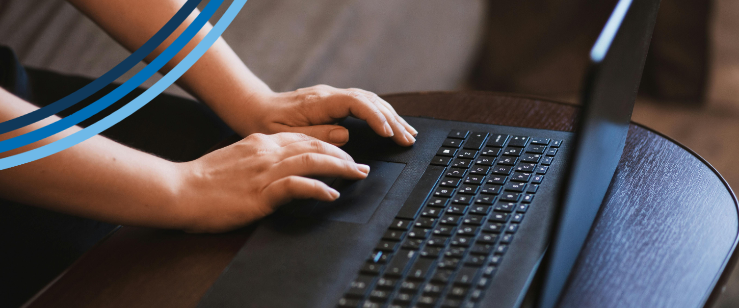 A person is typing on a black keyboard.