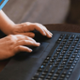 Innovative trial launched to test digital answer to identifying health inequalities A person is typing on a black keyboard.