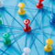Image for networks - Pins in a board with string attached to show different locations.