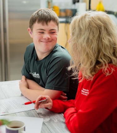 Lloyd Martin completes a Health Profile document with his mum, Ceri Hooper, who is holding a pen.