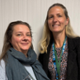 Two women are smiling.