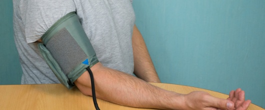 Image of a person having their blood pressure taken in a medical setting.