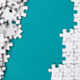 White puzzle Pieces on a green background