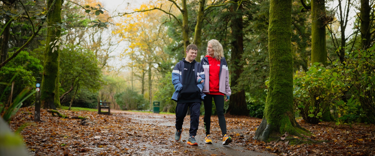 Lloyd Martin and his Mum Ceri Hooper walk through a park on a winter day.