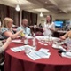 A group of people are sat around a table during a workshop.