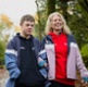 Lloyd Martin and his Mum, Ceri Hooper, walk arm in arm through the park.