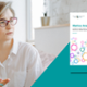 A healthcare professional is having a discussion. She is placed next to the front cover of a document.