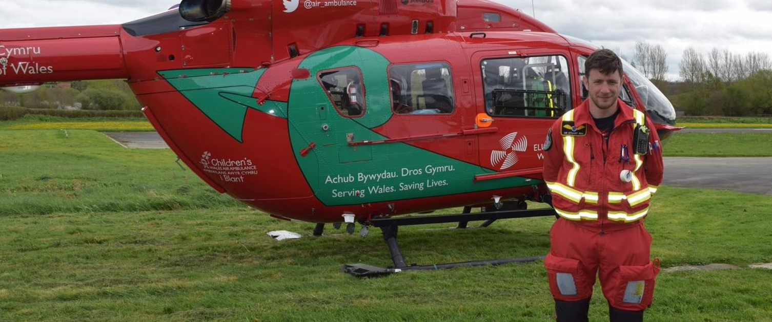 Dr Stuart Gill in front of a WAA helicopter