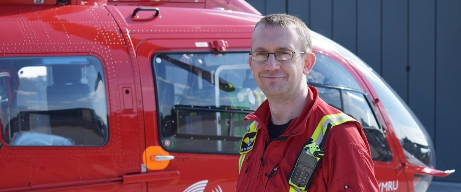 Dr Tim Rogerson next to a WAA helicopter