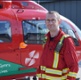 Dr Tim Rogerson next to a WAA helicopter