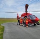 Four men next to a Wales Air Ambulance 