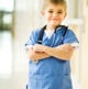 photo of a boy wearing doctors scrubs